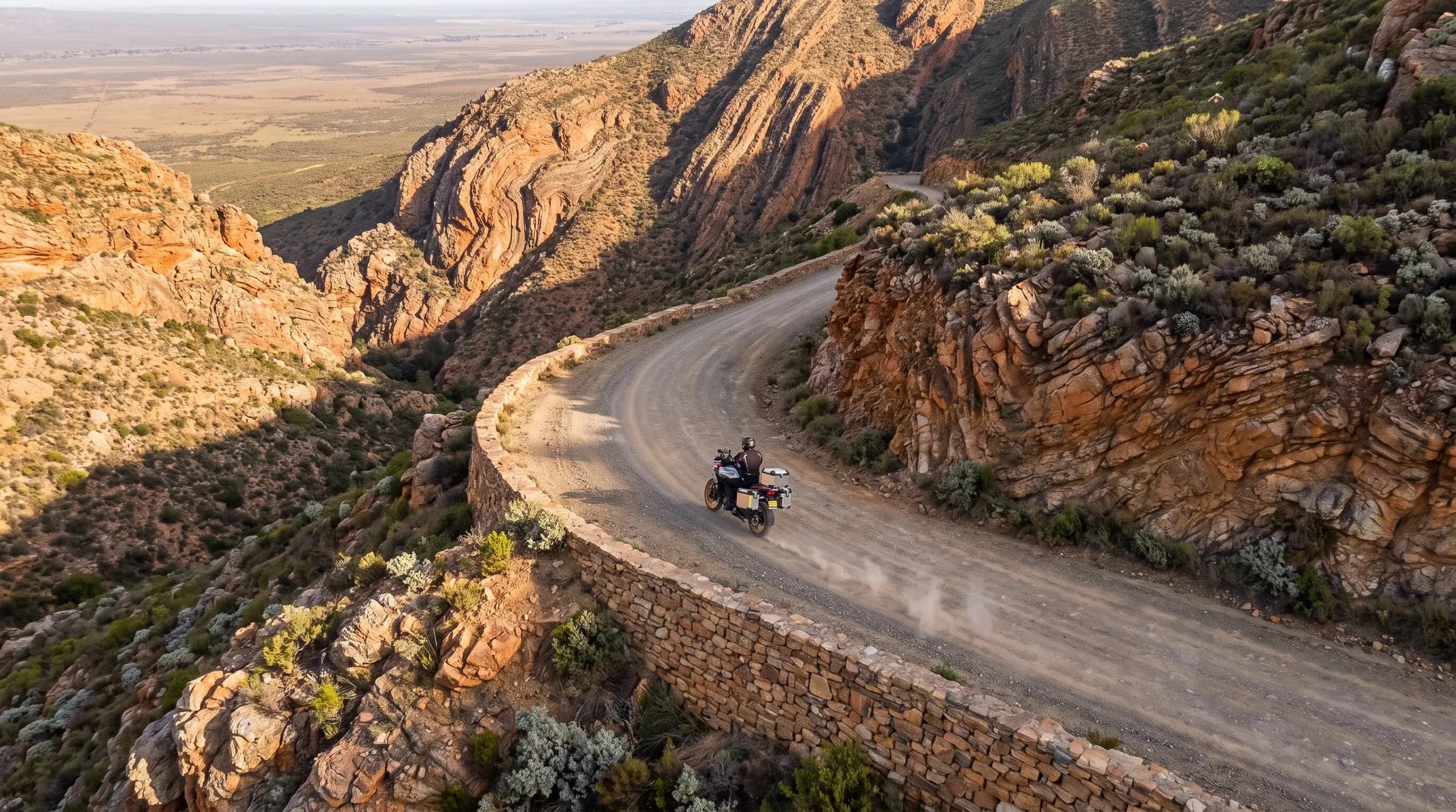A rider on a stone-walled gravel pass high in the Swartberg mountains